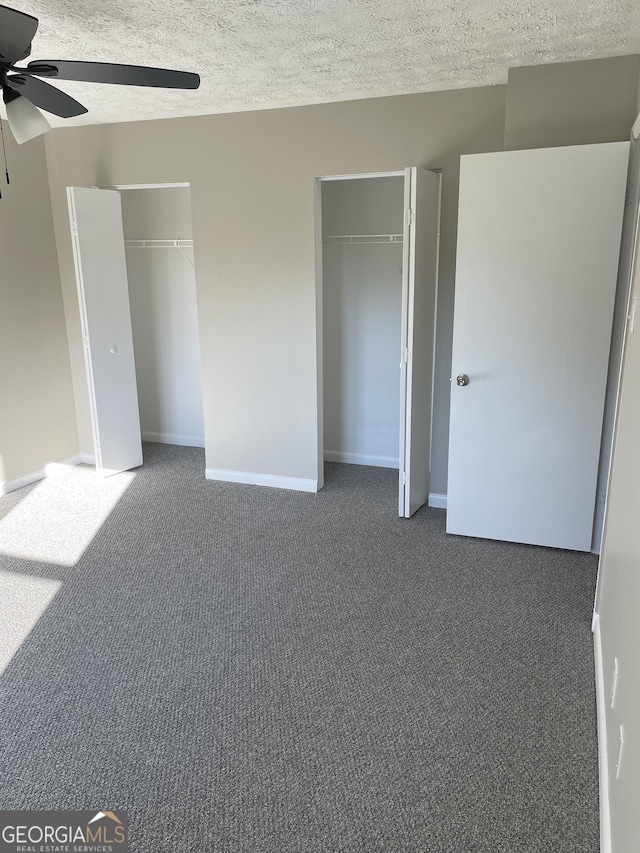 3621 Stedman Pl, Duluth, GA 30096 - unfurnished bedroom featuring multiple closets, carpet flooring, a textured ceiling, and a ceiling fan