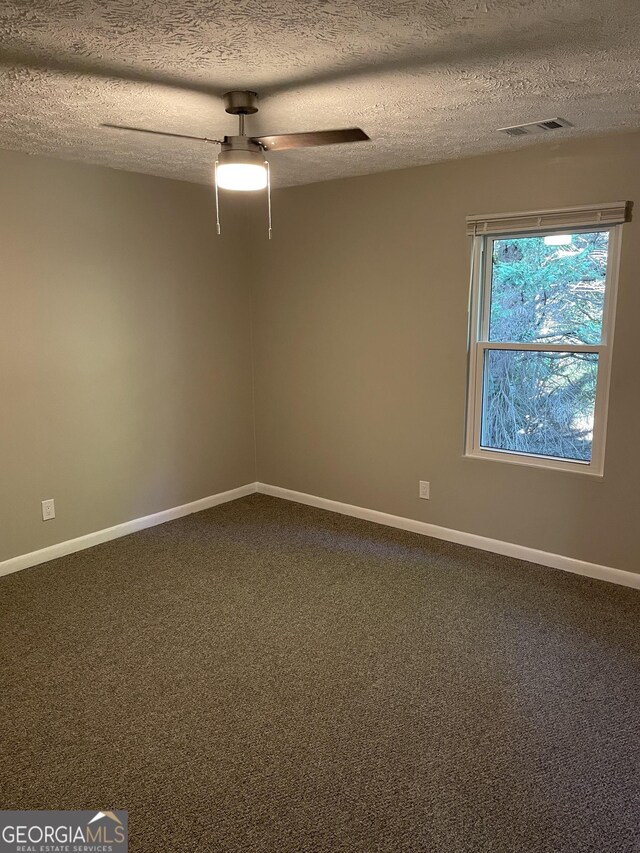 3621 Stedman Pl, Duluth, GA 30096 - spare room with dark carpet, a textured ceiling, and ceiling fan