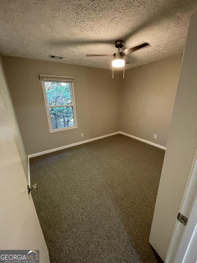 3621 Stedman Pl, Duluth, GA 30096 - spare room with a ceiling fan, a textured ceiling, and dark carpet