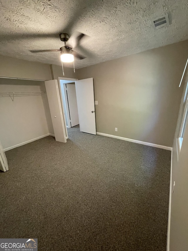 3621 Stedman Pl, Duluth, GA 30096 - unfurnished bedroom featuring dark colored carpet, a ceiling fan, a textured ceiling, and a closet