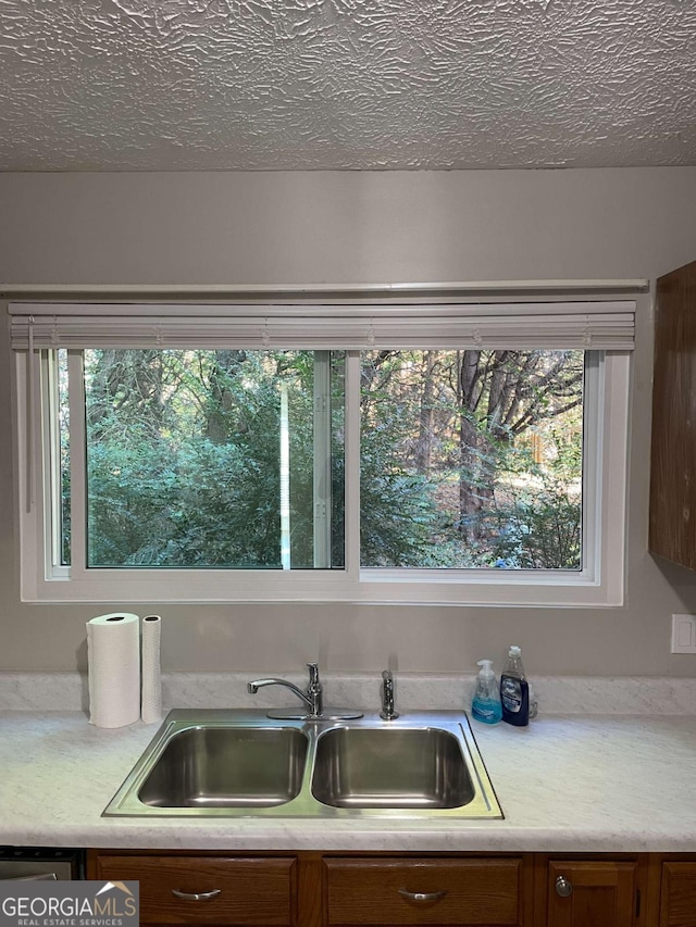 3621 Stedman Pl, Duluth, GA 30096 - kitchen with light countertops, brown cabinets, and a textured ceiling