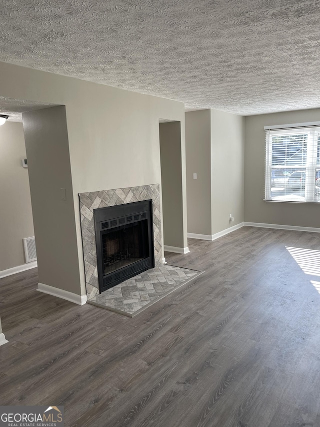 3621 Stedman Pl, Duluth, GA 30096 - unfurnished living room with wood finished floors, a fireplace, and a textured ceiling