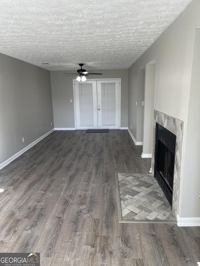 3621 Stedman Pl, Duluth, GA 30096 - unfurnished living room featuring a ceiling fan, wood finished floors, a textured ceiling, a fireplace, and french doors