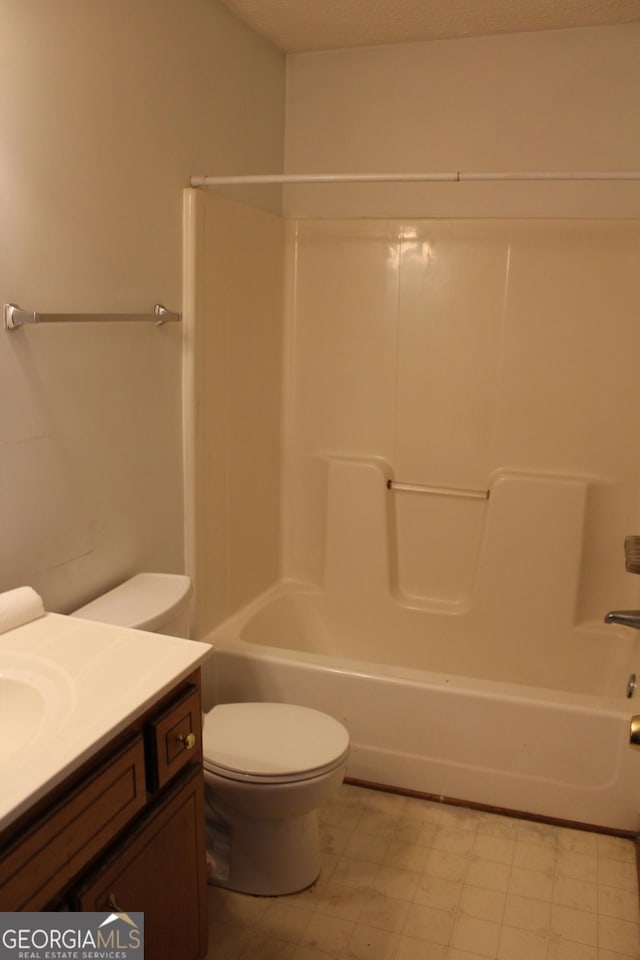full bath with tile patterned floors, shower / bathtub combination, vanity, and toilet