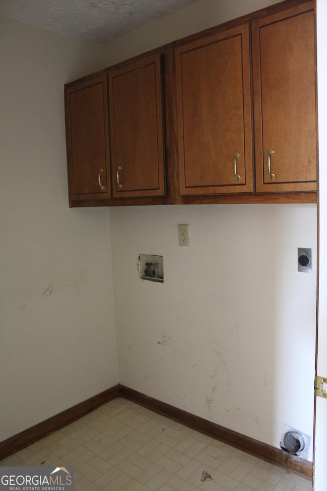 laundry room with light floors, hookup for an electric dryer, hookup for a washing machine, baseboards, and cabinet space
