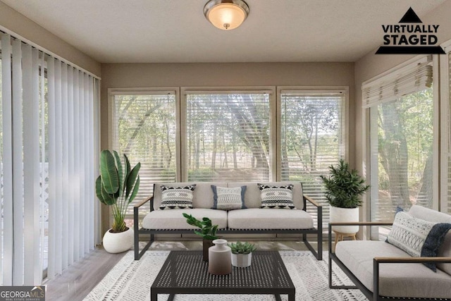 sunroom / solarium featuring wood finished floors