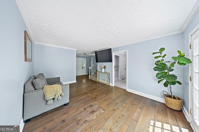 664 Somerset Dr, Lawrenceville, GA 30046 - sitting room with stairway, wood finished floors, baseboards, a textured ceiling, and ornamental molding