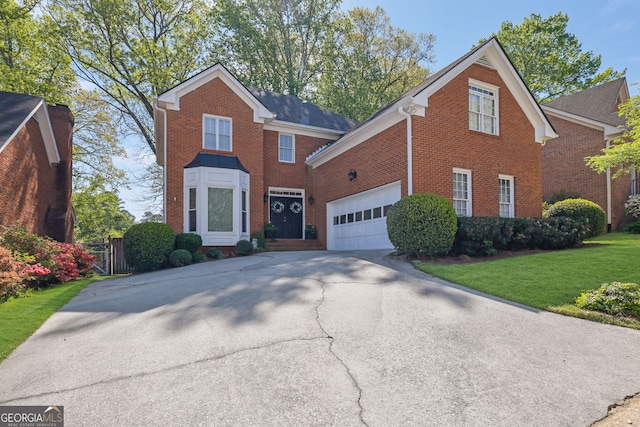 traditional-style house featuring brick siding, a front lawn, a garage, and driveway