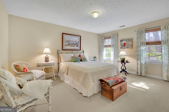 bedroom with light colored carpet, baseboards, and visible vents