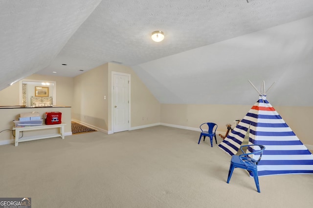 interior space with baseboards, vaulted ceiling, and carpet