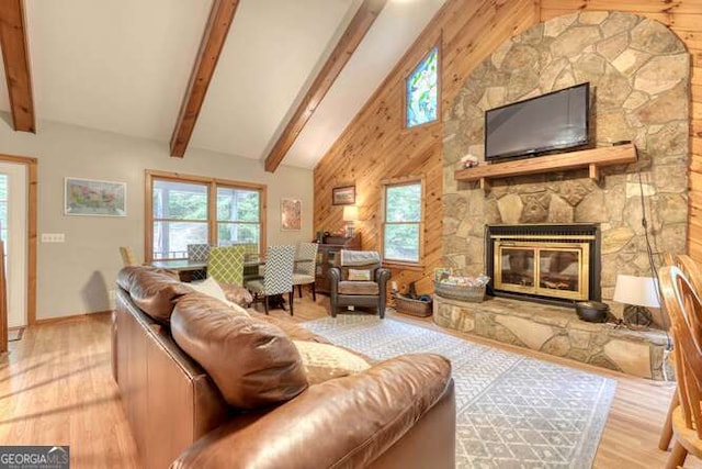 83 Smokey Creek Cv Tract B, Unit Tract B, Blairsville, GA 30512 - living room featuring wood finished floors, healthy amount of natural light, beam ceiling, a stone fireplace, and wood walls