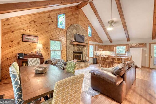 83 Smokey Creek Cv Tract B, Unit Tract B, Blairsville, GA 30512 - living area with light wood finished floors, beam ceiling, a stone fireplace, a ceiling fan, and high vaulted ceiling