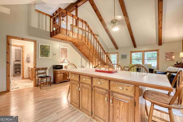 83 Smokey Creek Cv Tract B, Unit Tract B, Blairsville, GA 30512 - kitchen with high vaulted ceiling, a kitchen bar, light wood finished floors, beamed ceiling, and light countertops