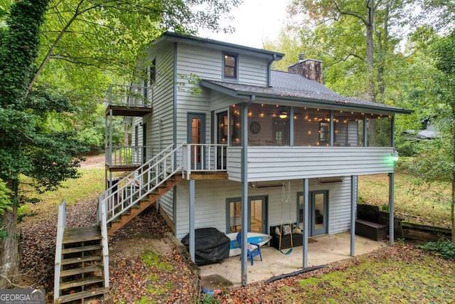 83 Smokey Creek Cv Tract B, Unit Tract B, Blairsville, GA 30512 - back of house with a sunroom, stairs, a patio area, a chimney, and a wooden deck