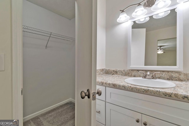 5350 Rockbridge Rd, Stone Mountain, GA 30088 - bathroom with vanity, baseboards, and a spacious closet