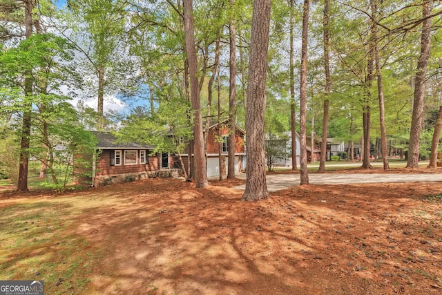 5350 Rockbridge Rd, Stone Mountain, GA 30088 - view of yard with a garage and driveway