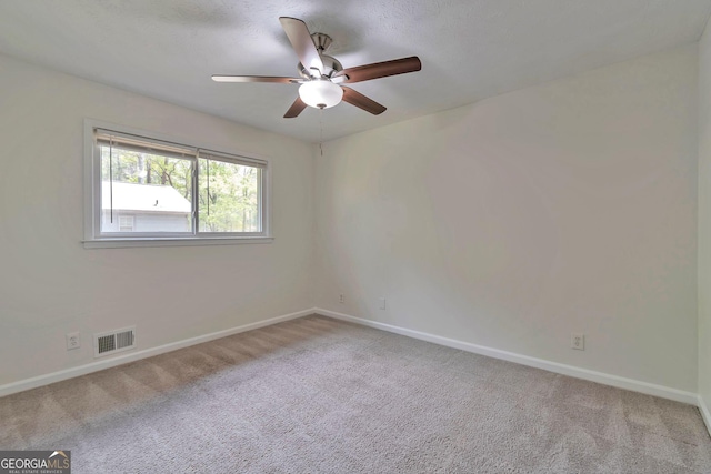 5350 Rockbridge Rd, Stone Mountain, GA 30088 - carpeted empty room featuring visible vents, baseboards, and ceiling fan