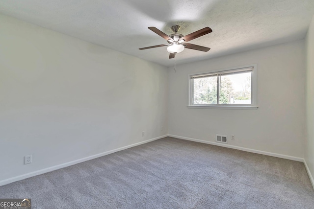 5350 Rockbridge Rd, Stone Mountain, GA 30088 - carpeted empty room with visible vents, ceiling fan, baseboards, and a textured ceiling
