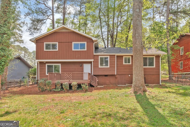 5350 Rockbridge Rd, Stone Mountain, GA 30088 - back of property featuring a yard, crawl space, a wooden deck, and fence