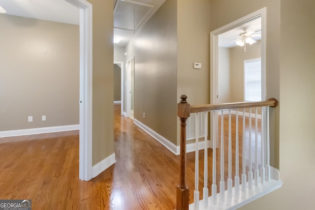 532 Zellner Rd, Forsyth, GA 31029 - corridor with attic access, wood finished floors, an upstairs landing, and baseboards