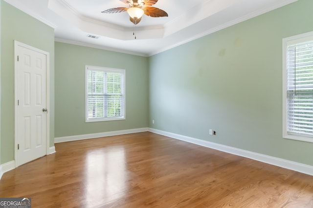 532 Zellner Rd, Forsyth, GA 31029 - empty room with a ceiling fan, a raised ceiling, wood finished floors, crown molding, and baseboards