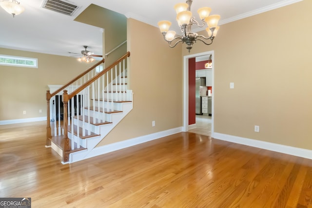 532 Zellner Rd, Forsyth, GA 31029 - stairway with ornamental molding, a chandelier, ceiling fan, wood finished floors, and baseboards