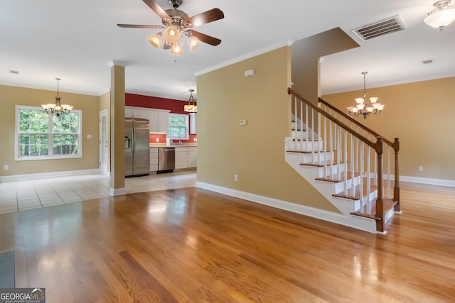 532 Zellner Rd, Forsyth, GA 31029 - unfurnished living room with a chandelier, baseboards, light wood-style flooring, and ornamental molding