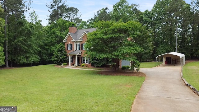 532 Zellner Rd, Forsyth, GA 31029 - view of front of home with a front lawn, concrete driveway, a carport, and a chimney
