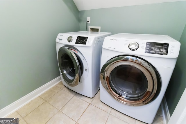 532 Zellner Rd, Forsyth, GA 31029 - laundry area with washing machine and clothes dryer, light tile patterned floors, and baseboards