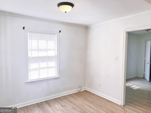 empty room featuring light wood-type flooring, baseboards, and a wealth of natural light