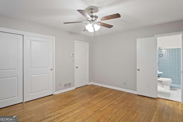 2732 Elkhorn Dr, Decatur, GA 30034 - unfurnished bedroom featuring wood finished floors, connected bathroom, a closet, baseboards, and visible vents