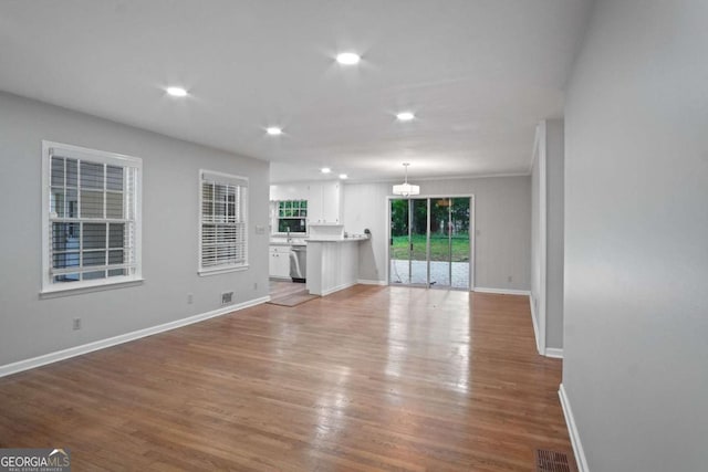 2732 Elkhorn Dr, Decatur, GA 30034 - unfurnished living room with a notable chandelier, wood finished floors, and baseboards