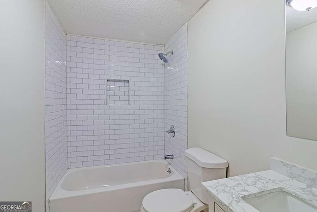 full bath featuring toilet, a textured ceiling, vanity, and washtub / shower combination