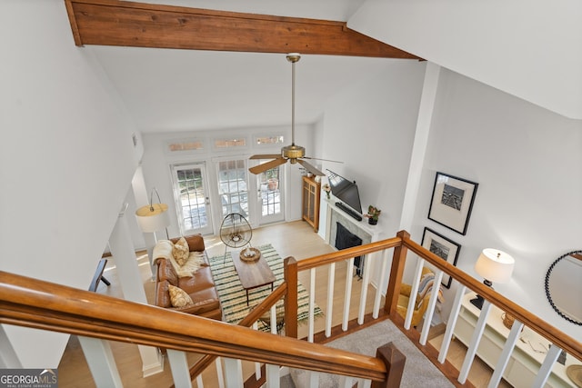 stairway featuring vaulted ceiling with beams and ceiling fan