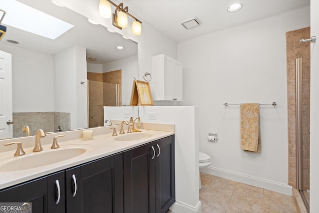 bathroom featuring a shower stall, tile patterned flooring, a sink, and a skylight