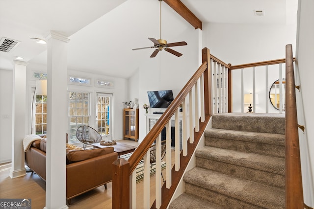 staircase featuring high vaulted ceiling, visible vents, a ceiling fan, and wood finished floors
