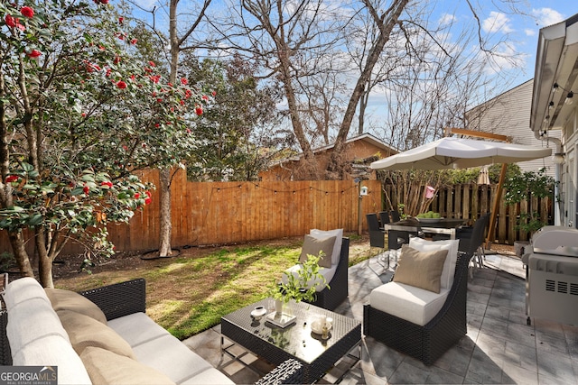 view of patio with an outdoor living space and a fenced backyard
