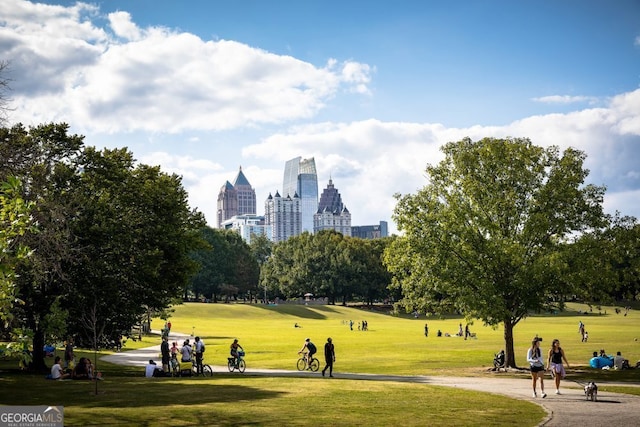 view of property's community featuring a yard and a view of city