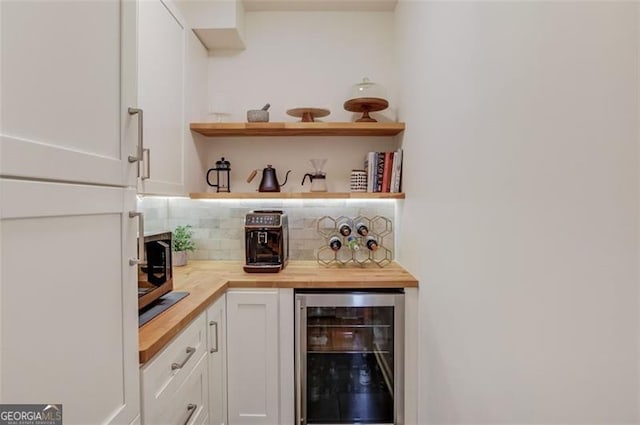 1038 Huntcliff, Atlanta, GA 30350 - bar with stainless steel microwave, backsplash, a dry bar, and wine cooler