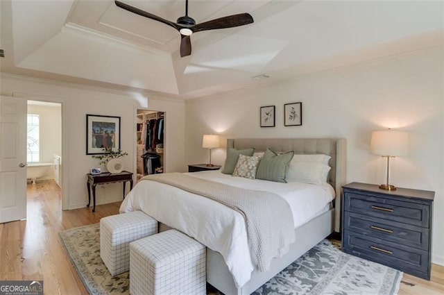 1038 Huntcliff, Atlanta, GA 30350 - bedroom with crown molding, a closet, a spacious closet, a raised ceiling, and light wood finished floors