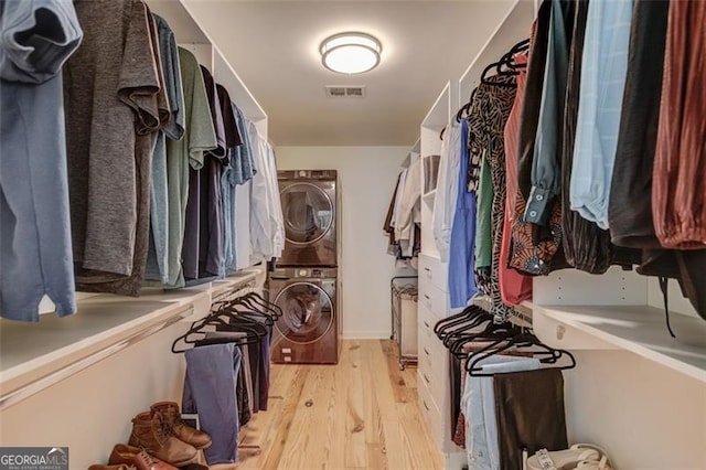 1038 Huntcliff, Atlanta, GA 30350 - spacious closet with light wood finished floors, stacked washer / dryer, and visible vents