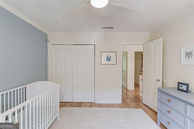 1038 Huntcliff, Atlanta, GA 30350 - bedroom with light wood finished floors, visible vents, a closet, and ornamental molding
