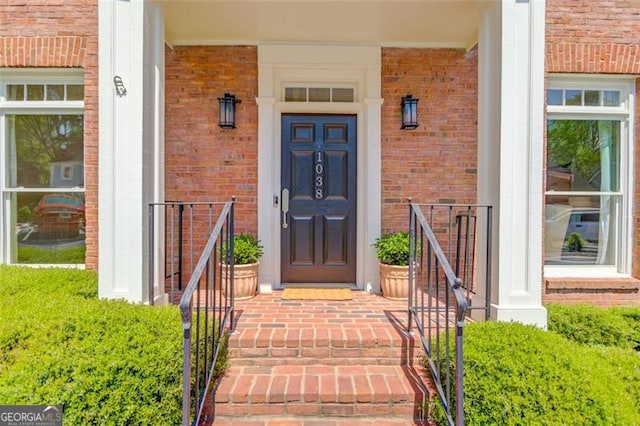 1038 Huntcliff, Atlanta, GA 30350 - doorway to property featuring covered porch and brick siding