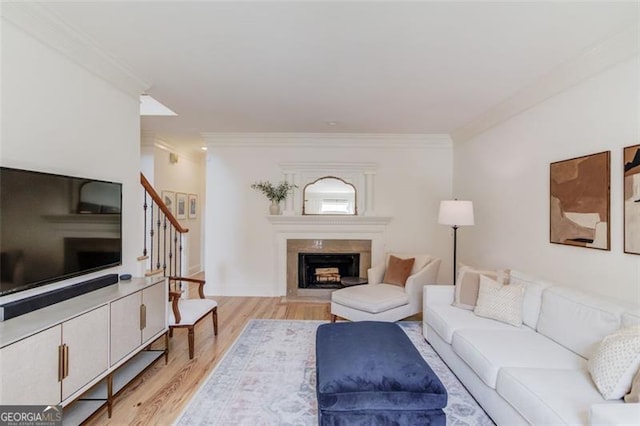 1038 Huntcliff, Atlanta, GA 30350 - living area featuring stairs, a high end fireplace, light wood-style flooring, and crown molding
