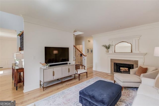 1038 Huntcliff, Atlanta, GA 30350 - living area featuring ornamental molding, stairway, wood finished floors, and a fireplace with flush hearth