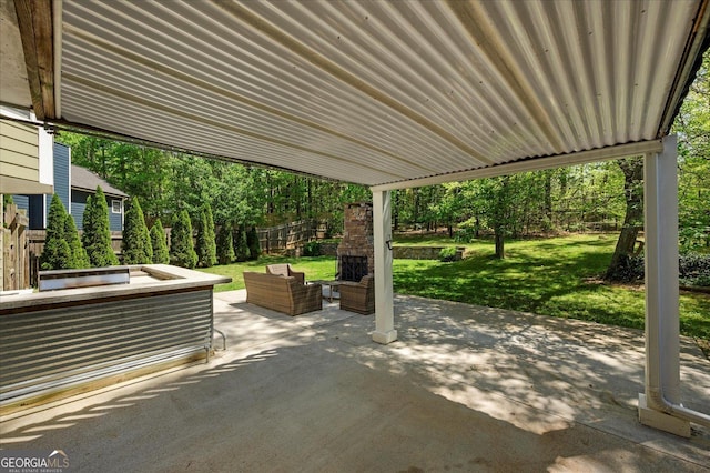 view of patio with fence and an outdoor living space with a fireplace