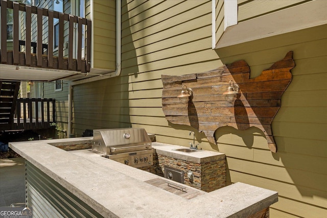 view of patio featuring an outdoor kitchen, grilling area, and a sink