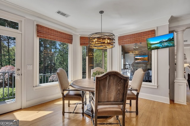 dining area featuring a chandelier, visible vents, crown molding, and a healthy amount of sunlight