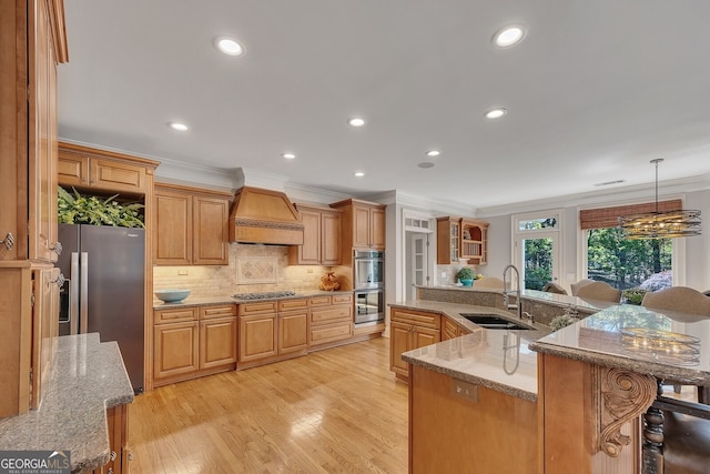 kitchen with tasteful backsplash, a sink, ornamental molding, premium range hood, and stainless steel appliances