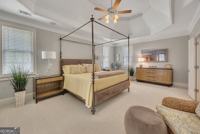 bedroom featuring crown molding, visible vents, a raised ceiling, and light carpet